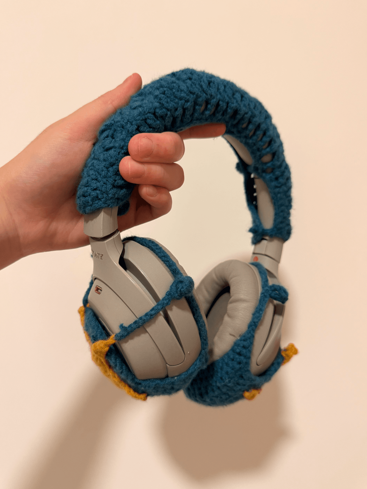 A pair of headphones with a crocheted cover set